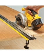 The Rockler 52'' to 104'' Low Profile Straight Edge Clamp System assisting a saw in cutting a board