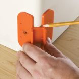 Rockler Bench Dog&reg; Bullnose Trim Gauge being used on corner of wall