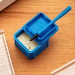 Rockler Silicone Glue Keeper with glue brush resting in lid and glue dripping into it.