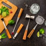 The Complete Set of Rockler Bar Turning Tools laid out on a table with a drink glass and ingredients ready to be used. 