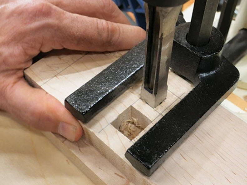 Cutting through mortise holes with mortising machine