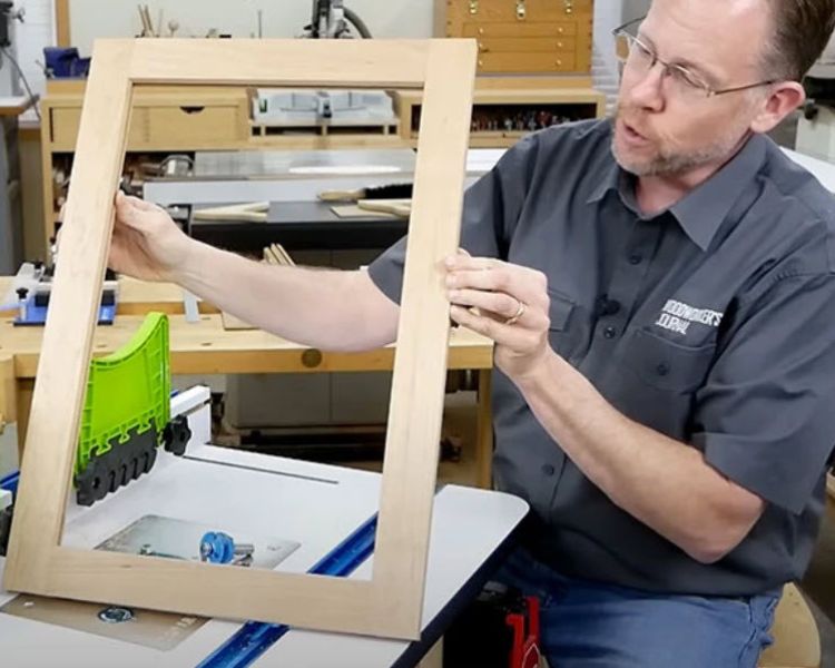 man holding diy shaker cabinet door frame