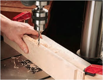 Using drill press to cut holes for mounting lattice