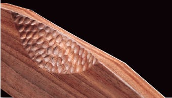 Carved pattern in crest rail
