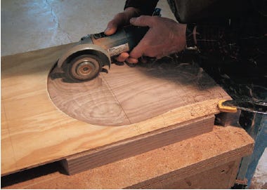 Using power grinder to cut chair contour