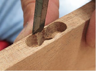 Cleaning hinge holes with a chisel