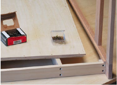 Interior view of corner assembly of entertainment center base with installed glue block