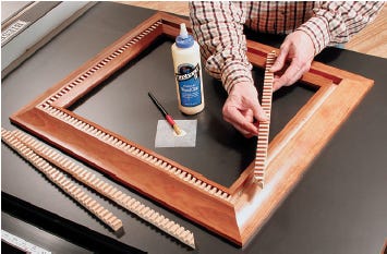Gluing dentil pattern into the picture frame