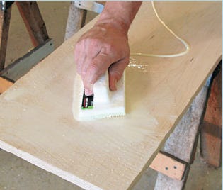Using a paint applicator to spread glue