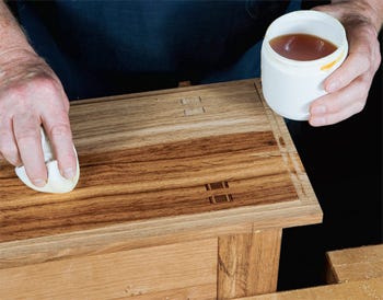 Applying one coat of shellac with cotton cloth