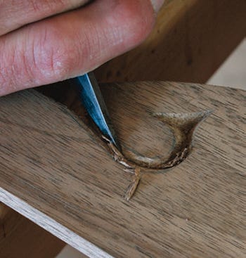 Adding a decorative carving to the crest rail
