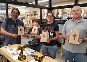 family showing off their finished luminary projects