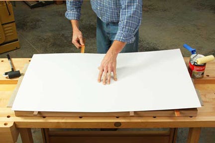 Using contact cement to attach plastic laminate to a tabletop