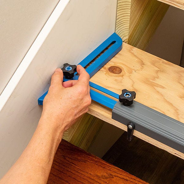 adjusting angle-finder arms to match wall angle.