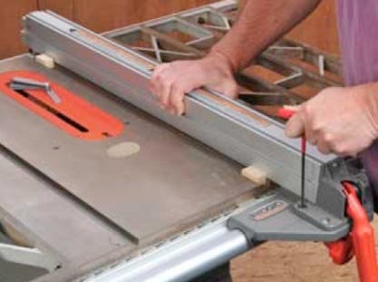 Making adjustments to screws on table saw fence