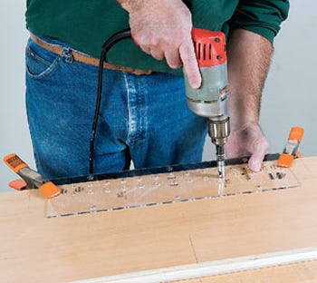Drilling holes with a shelf pin drilling guide