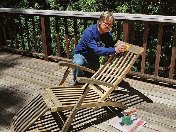 Wiping spar varnish on a deck chair