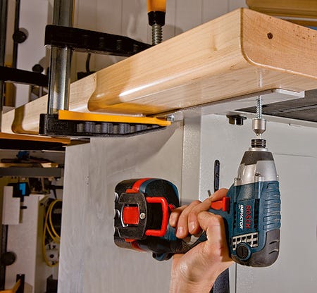 Screwing outfeed table mounting plate to cabinet saw fence railing