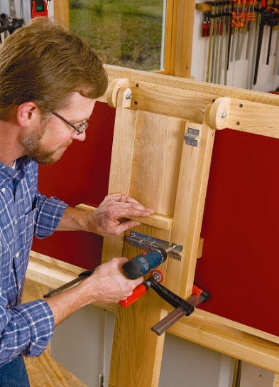 Screwing metal receiver into outfeed table to hold extending leg