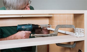Clamping undermount drawer slides in place to install them