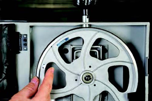 Adjusting tire on band saw wheel