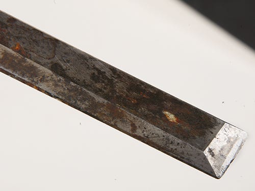 Close-up of worn and discolored bench chisel blade