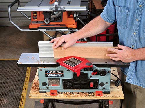 Running board through small benchtop jointer