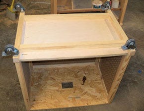 Underside of a sanding cart with casters installed on base frame