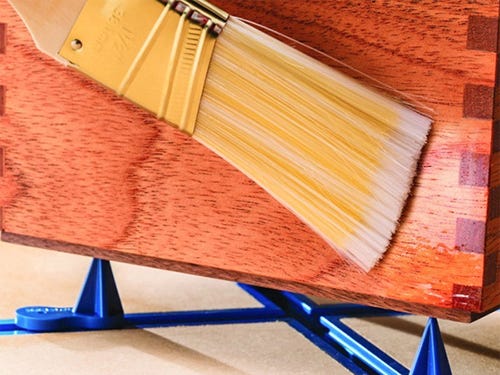 Brushing a wood finish on a box joint