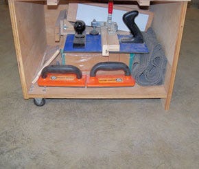 Shop cabinet with casters installed on one side and a solid foot on the other