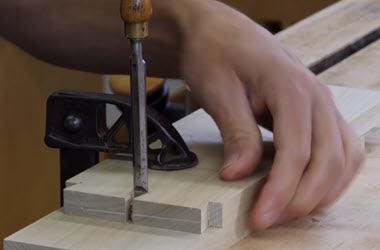 Using a chisel to clean a dovetail cut