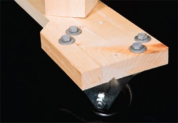 Securing caster wheels to the base of clamping cart