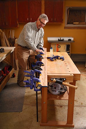 Clamping long picture frame molding to workbench