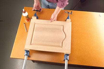 Applying pressure to door panel with bar clamps
