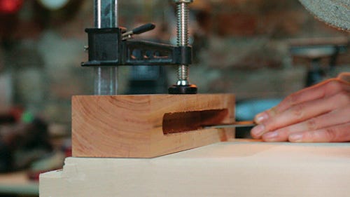 Trimming interior of breadboard joint with chisel
