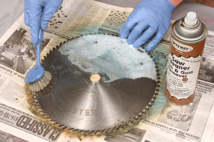 Cleaning a miter saw blade with solution and brush