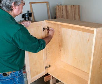 Finishing cabinet door and hinge installation