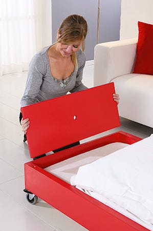 Storage space and foam pad in convertible coffee table bed