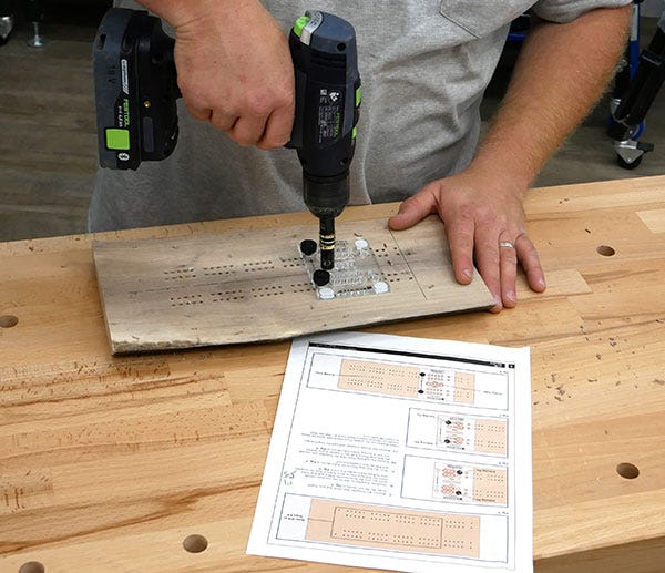 drilling cribbage board holes with template and drill
