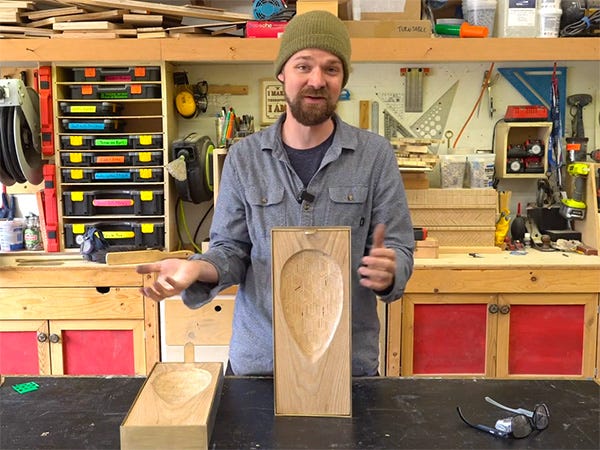 Michael Alm displays a carved wood wall sconce