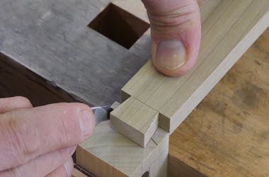 Cutting waste from dovetail joint with chisel