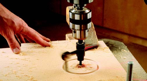 Using drill press and circle cutting bit to cut sanding cart top holes