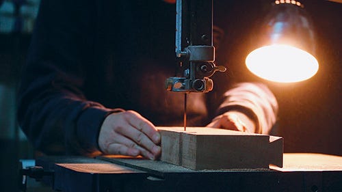 Using band saw to cut out mini workbench leg shape