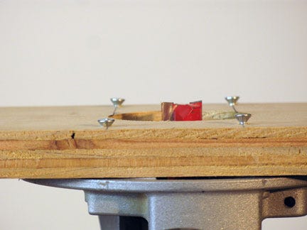 Close-up detail of screws coming out of surfacing jig