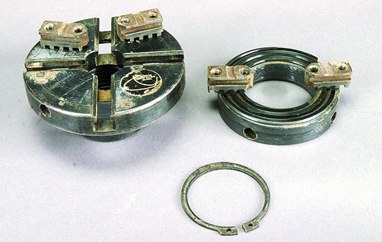 Parts of a four jaw scroll chuck taken apart for cleaning