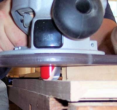 Router with dish-carving bit used to smooth ends of edge banding