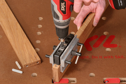 Using a drill to cut holes through dowel jig