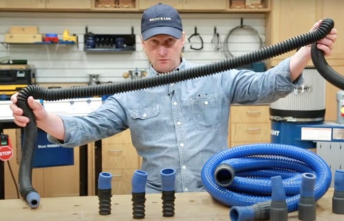 man holding dust collection hose