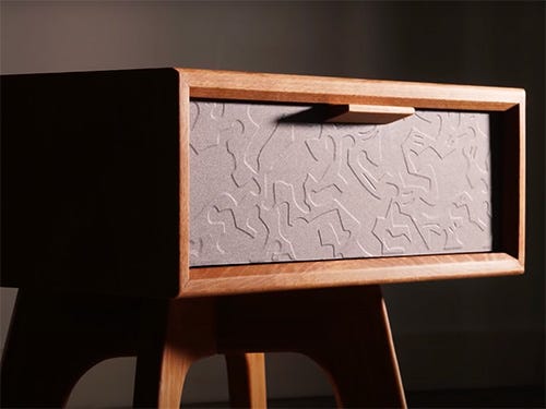 Nightstand with engraving carved into drawer face