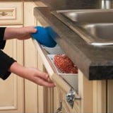 False drawer front in cabinet with tip-out storage